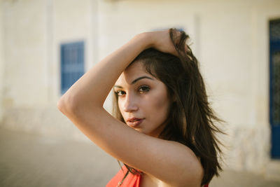 Portrait of beautiful woman standing at home