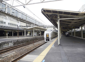 Train at railroad station platform against sky