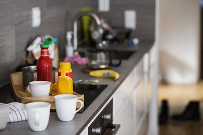 Cups and bottles on kitchen counter