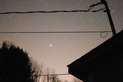 Low angle view of bare trees against sky at night