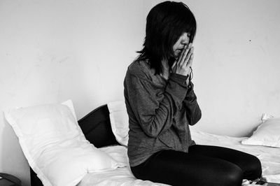 Young woman sitting at home