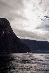 Scenic view of sea and mountains against sky