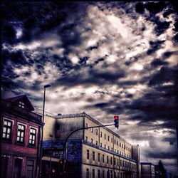 Low angle view of building against cloudy sky