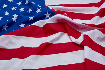 Close-up of crumpled american flag on wooden floor