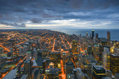 High angle view of illuminated city buildings against sky