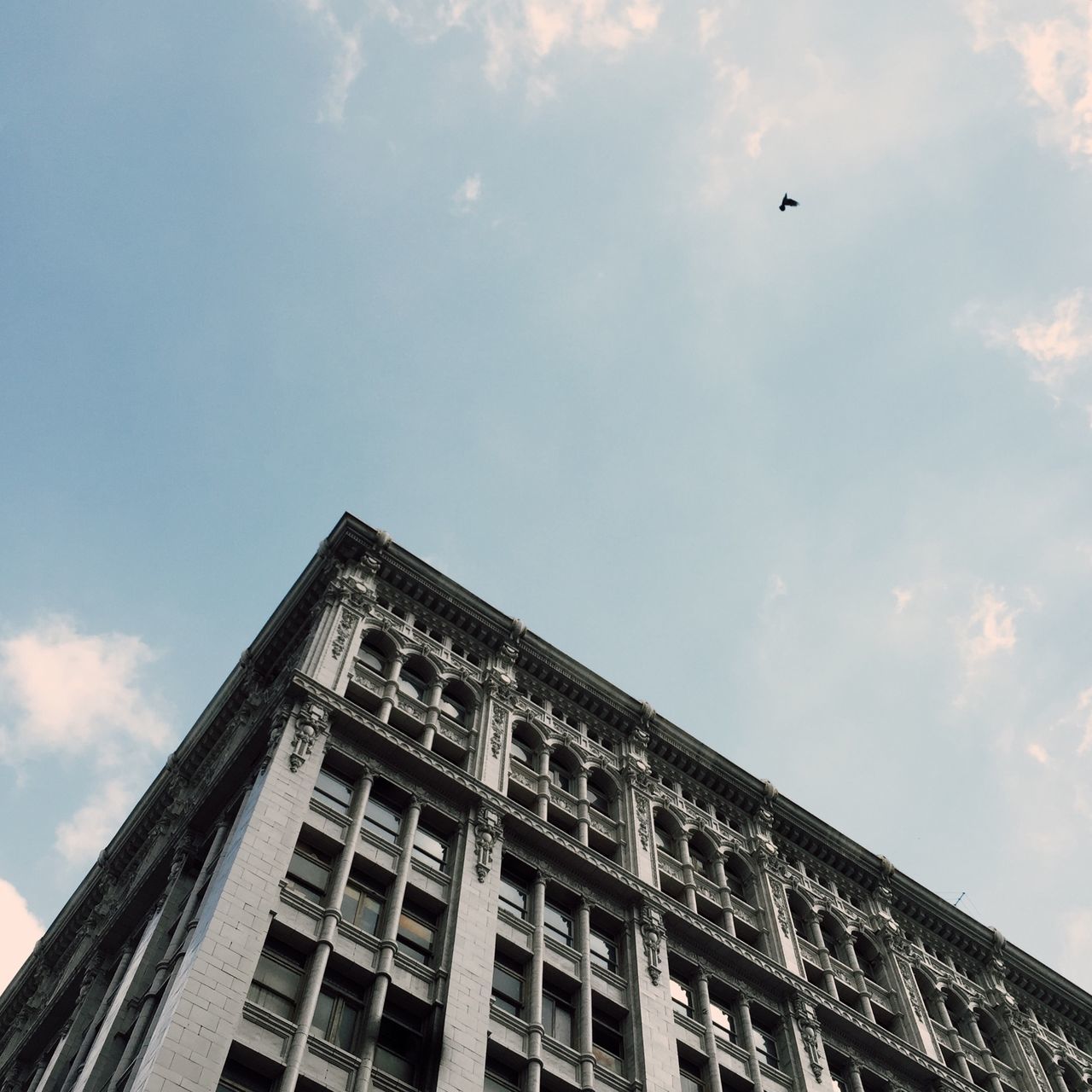 architecture, building exterior, low angle view, built structure, sky, city, cloud - sky, building, cloud, window, outdoors, day, modern, blue, residential building, no people, high section, office building, flying, residential structure