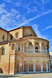 Low angle view of historical building against blue sky