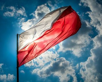 Low angle view of polish flag against sky