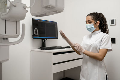 Nurse wearing protective glove in laboratory at maxillofacial clinic