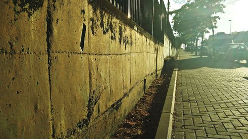 Surface level of cobblestone pathway by wall