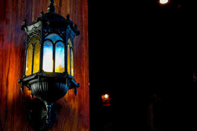 Illuminated lamp in temple at night