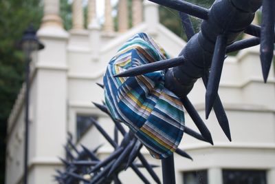 Close-up of bicycle hanging on railing