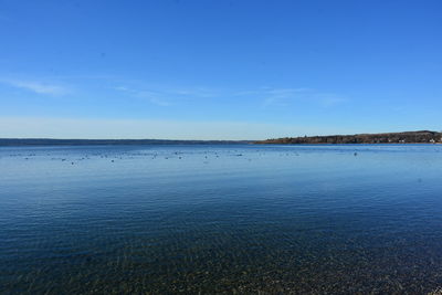 Scenic view of sea against blue sky