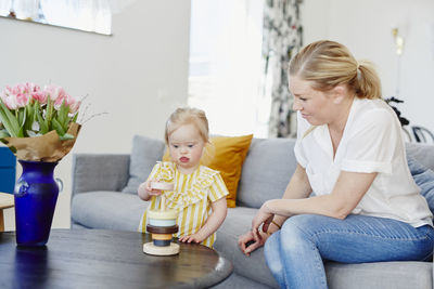 Mother and daughter sitting on floor