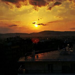 Silhouette cityscape against sky during sunset