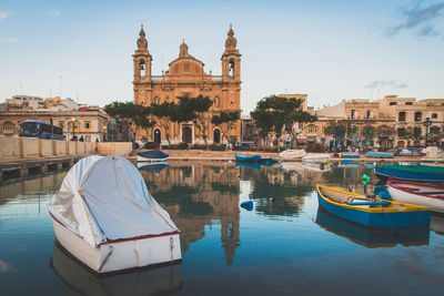 Boats on canal with buildings in background