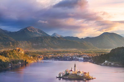 Scenic view of lake by mountains against sky