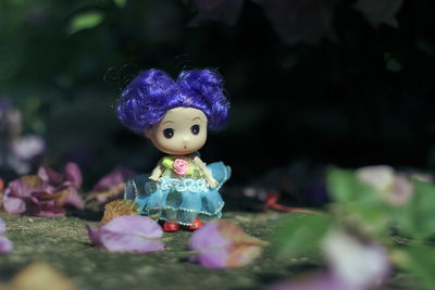 Close-up of toy figurine on purple flower