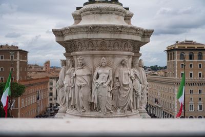 Statue of historic building against cloudy sky