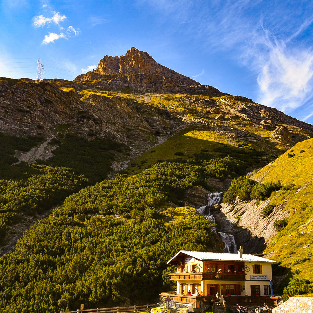 mountain, beauty in nature, scenics - nature, architecture, built structure, building exterior, sky, building, nature, no people, tranquil scene, cloud - sky, non-urban scene, tranquility, mountain range, plant, day, environment, tree, idyllic, outdoors