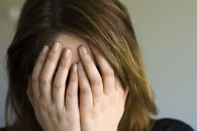 Portrait of woman covering face