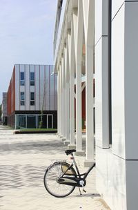 Bicycle on street amidst buildings in city