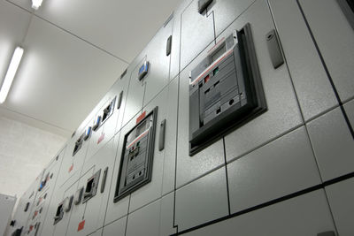 Low angle view of telephone booth in building