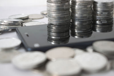 Stacked coins with mobile phone