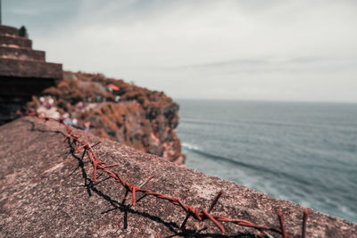 Scenic view of rocks in sea against sky