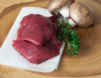 Close-up of meat and vegetables on cutting board