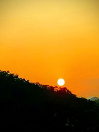 Scenic view of silhouette trees against romantic sky at sunset