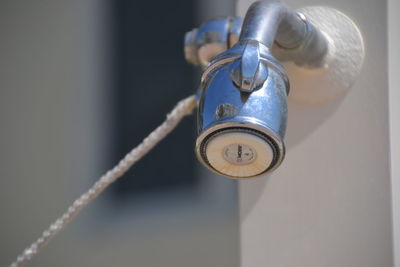 Close-up of tap against the wall