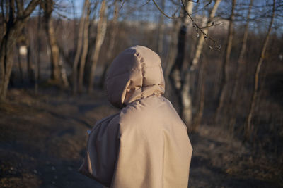 Rear view of woman standing on field