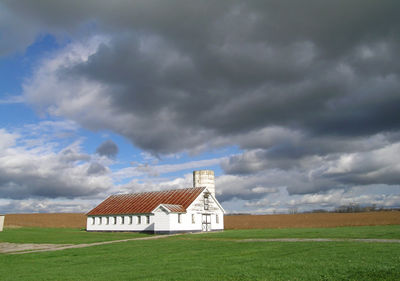 Built structure on field against sky