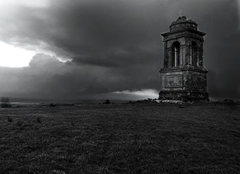 Built structures against cloudy sky