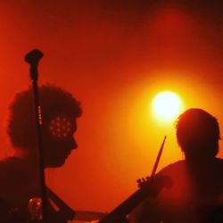 Silhouette man playing against sky at night