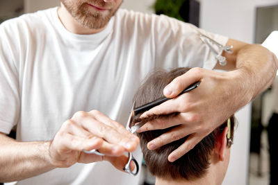 Midsection of man using mobile phone