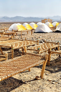 Chairs and parasols on beach against sky