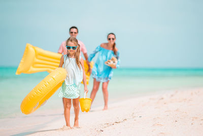 Full length of siblings on beach