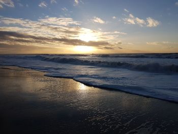 Scenic view of beach against sky during sunset