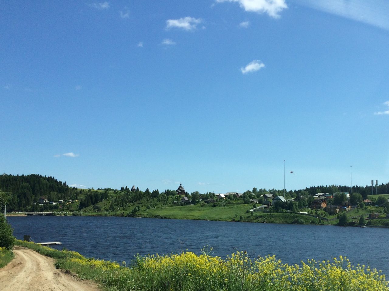 water, sky, blue, tranquil scene, tranquility, river, lake, tree, beauty in nature, scenics, nature, plant, built structure, growth, landscape, architecture, day, no people, building exterior, outdoors