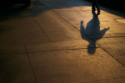 Low section of person walking on sidewalk