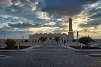 Building against cloudy sky during sunset