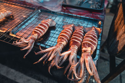 High angle view of meat on barbecue grill