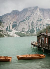 Scenic view of lake by mountains against sky