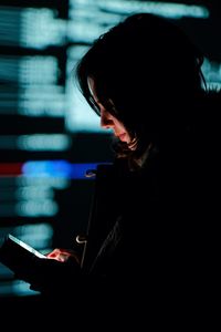 Side view of woman using mobile phone