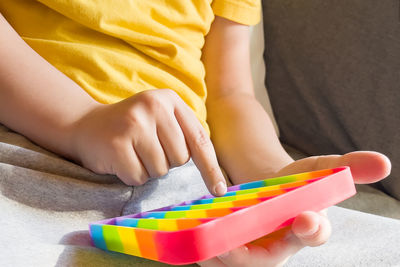 Midsection of woman playing with toy