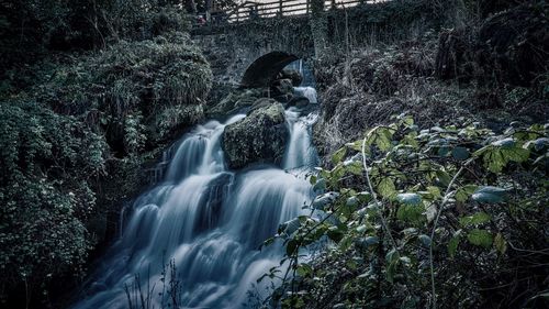 Man looking at waterfall