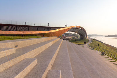 Road by bridge against clear sky