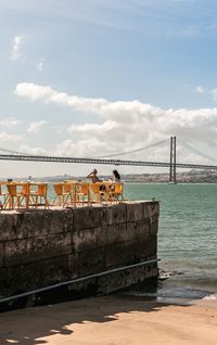 Bridge over sea against sky